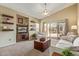 Bright living room with sliding glass doors, comfortable seating area and carpet flooring at 40901 N Courage Trl, Anthem, AZ 85086