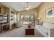 Living room featuring a comfortable seating area, large sliding glass doors, and a neutral color palette at 40901 N Courage Trl, Anthem, AZ 85086