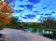 Relaxing pond-side view with a bench and autumn leaves at 40901 N Courage Trl, Anthem, AZ 85086