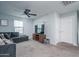 Bedroom with sectional sofa, ceiling fan, and large TV at 416 N 110Th Ave, Avondale, AZ 85323