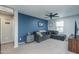 Bedroom with a large sectional sofa and ceiling fan at 416 N 110Th Ave, Avondale, AZ 85323