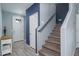 Entryway with stairs, gray tile floor, and a blue accent wall at 416 N 110Th Ave, Avondale, AZ 85323