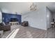 Spacious living room with dark brown sofas and a blue accent wall at 416 N 110Th Ave, Avondale, AZ 85323