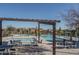 Community pool area with tables and chairs under pergola at 416 N 110Th Ave, Avondale, AZ 85323