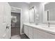 Double vanity bathroom with white cabinets and quartz countertops at 4229 N 32Nd Ave, Phoenix, AZ 85017