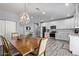 Bright dining area adjacent to kitchen, featuring a wood table and chandelier at 4229 N 32Nd Ave, Phoenix, AZ 85017