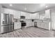 Modern kitchen with white shaker cabinets, stainless steel appliances, and gray flooring at 4229 N 32Nd Ave, Phoenix, AZ 85017