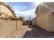 Backyard with block wall and gravel driveway leading to a wooden gate at 4250 E Towne Ln, Gilbert, AZ 85234