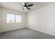 Bright bedroom with ceiling fan and gray carpeting at 4250 E Towne Ln, Gilbert, AZ 85234