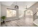 Dining area with wood-look floors, large window, and a ceiling fan at 4250 E Towne Ln, Gilbert, AZ 85234