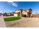 Two-story house with beige exterior, two-car garage, and landscaped lawn at 4250 E Towne Ln, Gilbert, AZ 85234