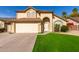 Two-story house with a beige exterior, two-car garage, and landscaped lawn at 4250 E Towne Ln, Gilbert, AZ 85234