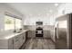 Modern kitchen with gray and white cabinets and a center island at 4250 E Towne Ln, Gilbert, AZ 85234