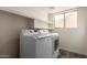 Bright laundry room with washer, dryer, and shelving at 4250 E Towne Ln, Gilbert, AZ 85234