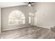 Living room with vaulted ceilings, wood-look floors, and a large window at 4250 E Towne Ln, Gilbert, AZ 85234