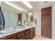 Double vanity bathroom with updated fixtures and cabinetry at 4348 E Sheena Dr, Phoenix, AZ 85032