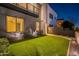 Home featuring an enclosed backyard with artificial turf, landscaping and modern fence at dusk at 4354 N 27Th Pl, Phoenix, AZ 85016