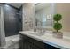 Modern bathroom featuring stylish dark tiled shower, sleek vanity and decor at 4354 N 27Th Pl, Phoenix, AZ 85016