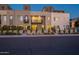 Modern townhomes featuring neutral stucco, black framed windows, and small balconies at dusk at 4354 N 27Th Pl, Phoenix, AZ 85016