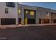 Modern townhome garage featuring black doors and neutral stucco at dusk at 4354 N 27Th Pl, Phoenix, AZ 85016