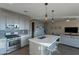 Open-concept kitchen featuring stainless appliances, grey cabinetry, an island, and pendant lighting at 4354 N 27Th Pl, Phoenix, AZ 85016