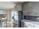 Bright kitchen showcasing stainless appliances, white cabinets, and dining area with natural light at 4354 N 27Th Pl, Phoenix, AZ 85016