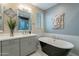 This bathroom boasts a black soaking tub, a patterned tile shower, and modern decor at 4354 N 27Th Pl, Phoenix, AZ 85016