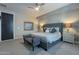 This main bedroom features carpet flooring, a ceiling fan, stylish decor, and a gray accent wall at 4354 N 27Th Pl, Phoenix, AZ 85016