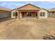 Large backyard with a covered patio and a tan stucco house at 4421 W Pleasant Ln, Laveen, AZ 85339