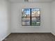 Simple bedroom with carpeted floor and large window at 4421 W Pleasant Ln, Laveen, AZ 85339