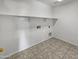 Laundry room with built-in shelving and tile flooring at 4421 W Pleasant Ln, Laveen, AZ 85339