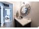 Vanity with a white quartz countertop and a black metal framed mirror at 45 E Woodward Dr, Phoenix, AZ 85004