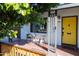 Modern front door with yellow paint and wood accents at 45 E Woodward Dr, Phoenix, AZ 85004