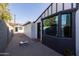 Side yard with cornhole and detached studio at 45 E Woodward Dr, Phoenix, AZ 85004