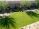 Large grassy backyard with a curved landscape design at 45717 W Ranch Rd, Maricopa, AZ 85139