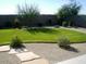 Spacious backyard featuring a well-manicured lawn and stone accents at 45717 W Ranch Rd, Maricopa, AZ 85139