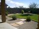 Landscaped backyard with grassy area, gravel, and stone pathways at 45717 W Ranch Rd, Maricopa, AZ 85139