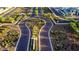 Aerial view of community entrance with landscaped medians and curving roadways at 4931 E Village Dr, Scottsdale, AZ 85254