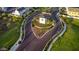 Aerial view of community entrance with a clock tower and landscaped roundabout at 4931 E Village Dr, Scottsdale, AZ 85254