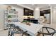 Bright dining area with white table and blue chairs at 4931 E Village Dr, Scottsdale, AZ 85254