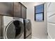 Laundry room with Whirlpool washer and dryer at 4931 E Village Dr, Scottsdale, AZ 85254