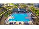 Community pool with lounge chairs, umbrellas, and a clubhouse at 4931 E Village Dr, Scottsdale, AZ 85254