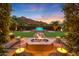 Relaxing backyard with fire pit, water feature, and mountain backdrop at 4949 E Lincoln Dr # 34, Paradise Valley, AZ 85253