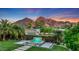 Landscaped backyard oasis with a water feature and mountain views at 4949 E Lincoln Dr # 34, Paradise Valley, AZ 85253