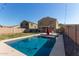 Inviting backyard oasis with a sparkling pool and patio area at 5496 S 237Th Ln, Buckeye, AZ 85326