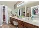 Double vanity bathroom with walk-in closet and shower at 5496 S 237Th Ln, Buckeye, AZ 85326