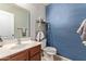 Clean bathroom with updated vanity and blue patterned walls at 5496 S 237Th Ln, Buckeye, AZ 85326