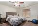 Large bedroom with ceiling fan and carpeted floors at 5496 S 237Th Ln, Buckeye, AZ 85326