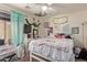 Cozy bedroom featuring a bed, television, and decorative elements at 5496 S 237Th Ln, Buckeye, AZ 85326