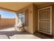 Cozy front porch with a bench and security door, offering a welcoming entrance at 5496 S 237Th Ln, Buckeye, AZ 85326